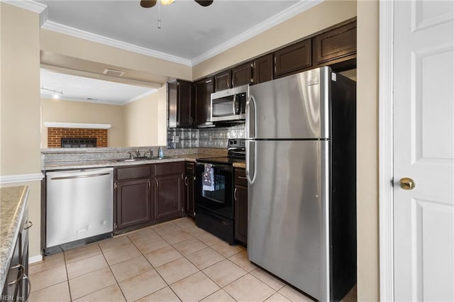 kitchen featuring decorative backsplash, appliances with stainless steel finishes, ornamental molding, dark brown cabinets, and light tile patterned flooring