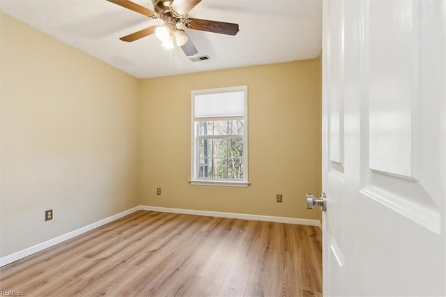 unfurnished room featuring light wood-type flooring, visible vents, ceiling fan, and baseboards