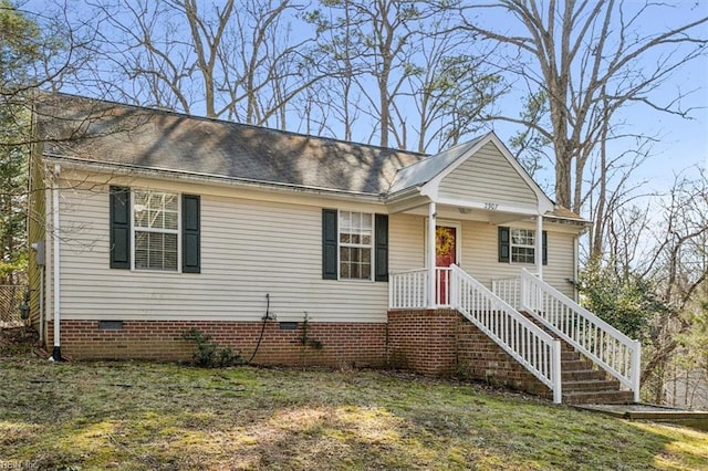 view of front of house featuring a shingled roof and crawl space