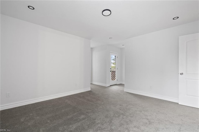 empty room featuring carpet, baseboards, and recessed lighting