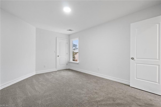 carpeted empty room with baseboards and visible vents