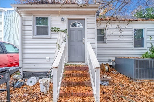 property entrance featuring central AC unit