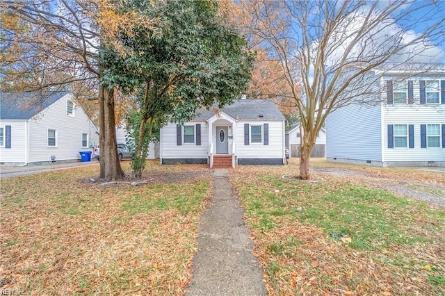 view of front of home with crawl space and a front yard