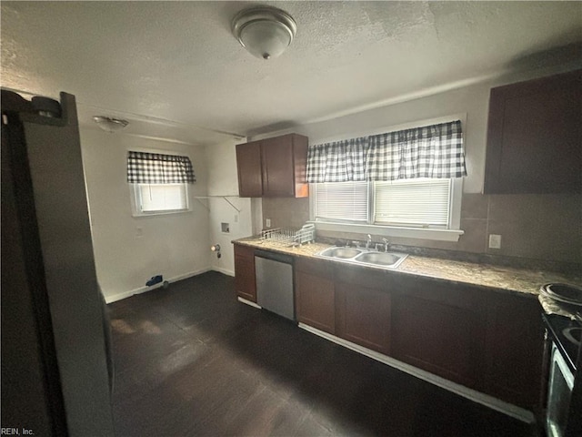 kitchen with dishwasher, light countertops, a textured ceiling, and a sink