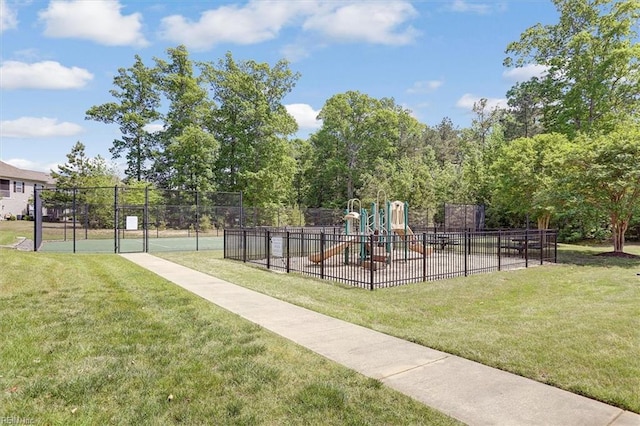 view of home's community with playground community, fence, and a lawn