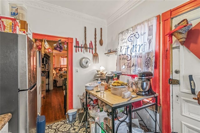 kitchen featuring ornamental molding and freestanding refrigerator