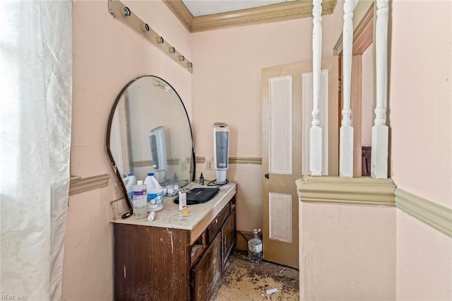 bathroom with crown molding and vanity