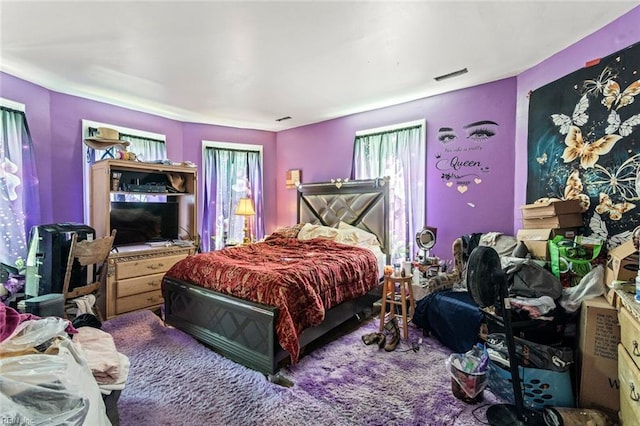 carpeted bedroom featuring visible vents