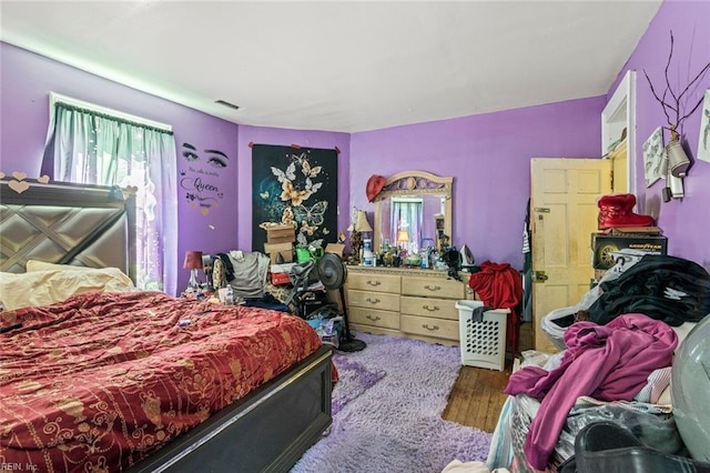 bedroom with visible vents and wood finished floors