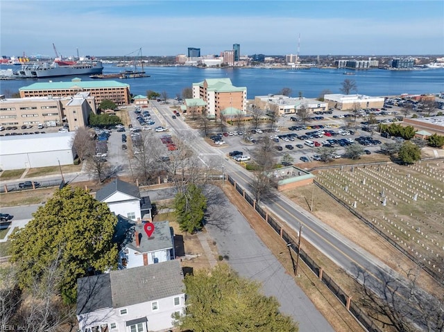 birds eye view of property featuring a water view and a city view