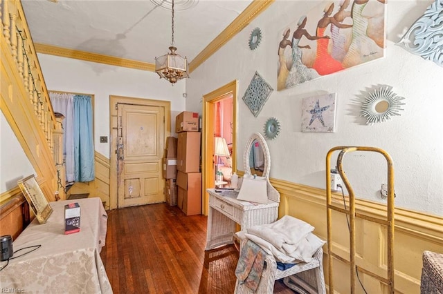 interior space featuring dark wood-type flooring, wainscoting, and crown molding