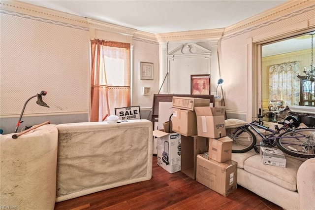 sitting room with ornamental molding, wood finished floors, and wallpapered walls