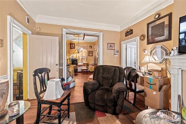 living room with ornamental molding, a chandelier, and wood finished floors