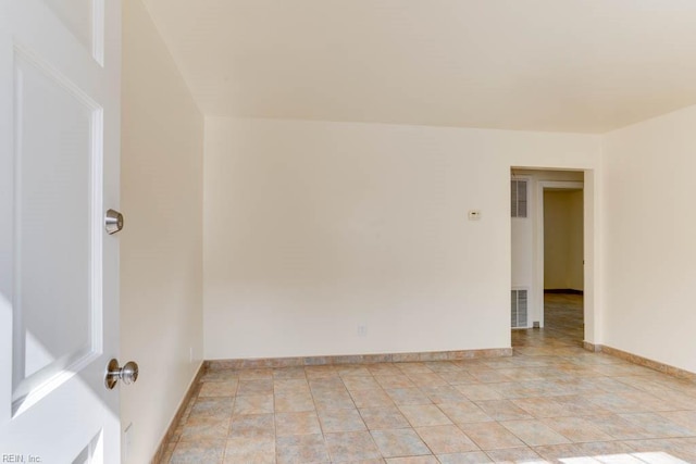 unfurnished room featuring visible vents and baseboards