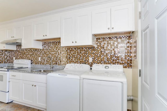 laundry area with independent washer and dryer and a sink