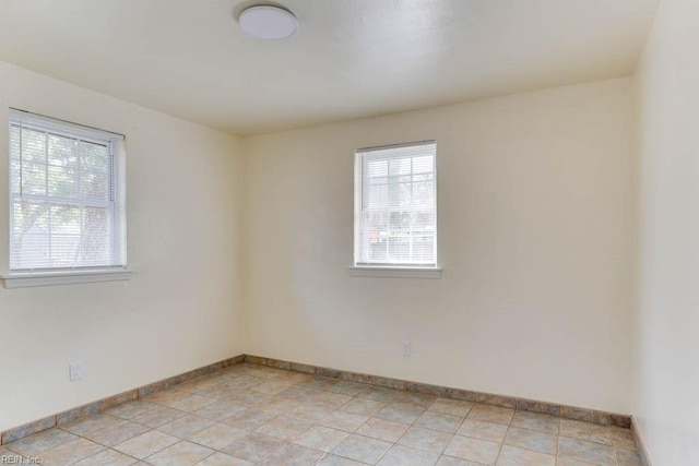 spare room featuring baseboards