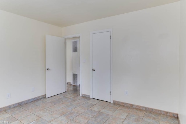 empty room featuring visible vents and baseboards