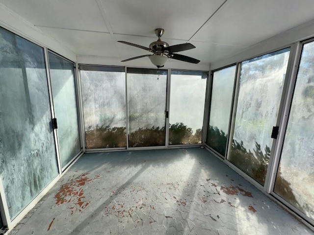 unfurnished sunroom featuring ceiling fan