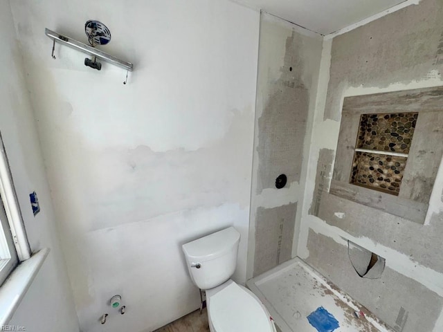 bathroom with walk in shower and toilet