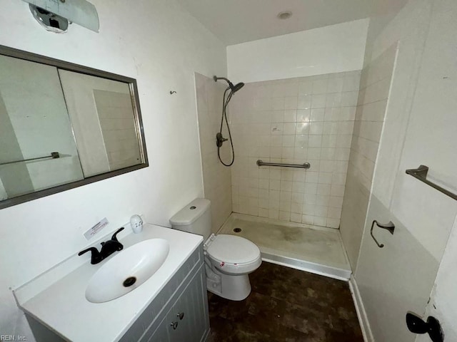 full bathroom with vanity, a shower stall, and toilet