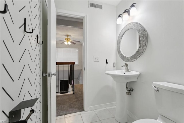 bathroom featuring visible vents, baseboards, toilet, ceiling fan, and tile patterned flooring