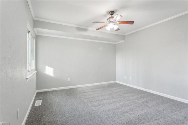 carpeted spare room featuring ornamental molding, visible vents, baseboards, and a ceiling fan