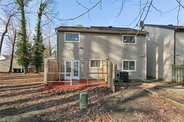 back of property with central air condition unit, fence, and french doors