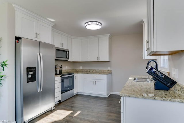 kitchen featuring stainless steel appliances, white cabinetry, dark wood finished floors, and light stone countertops