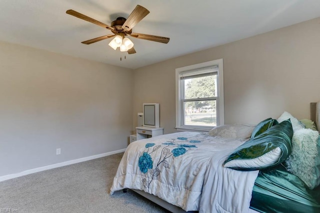 carpeted bedroom with ceiling fan and baseboards