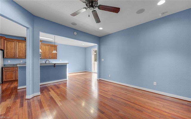 interior space featuring hardwood / wood-style flooring, ceiling fan, baseboards, and recessed lighting