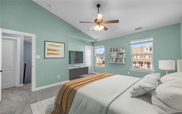 carpeted bedroom with lofted ceiling, baseboards, visible vents, and ceiling fan