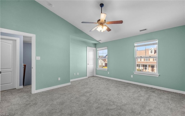 unfurnished bedroom with carpet floors, lofted ceiling, visible vents, and baseboards