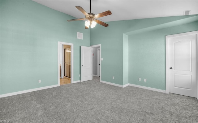 unfurnished bedroom featuring high vaulted ceiling, carpet floors, visible vents, baseboards, and ensuite bath