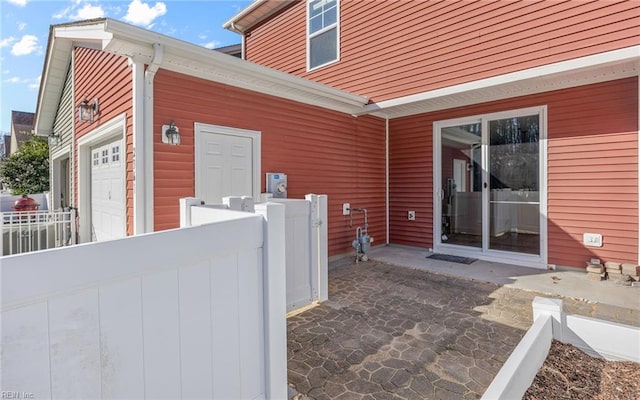 exterior space with a garage and fence