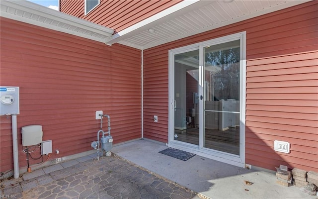 entrance to property featuring a patio area