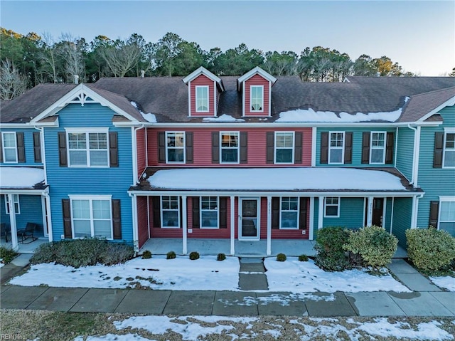 townhome / multi-family property featuring a porch