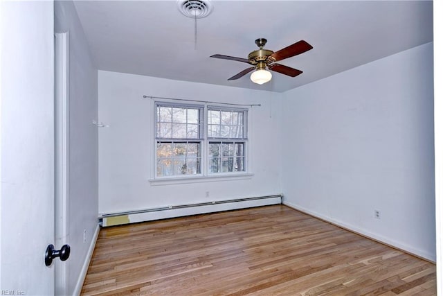 unfurnished room featuring a ceiling fan, visible vents, baseboard heating, and wood finished floors