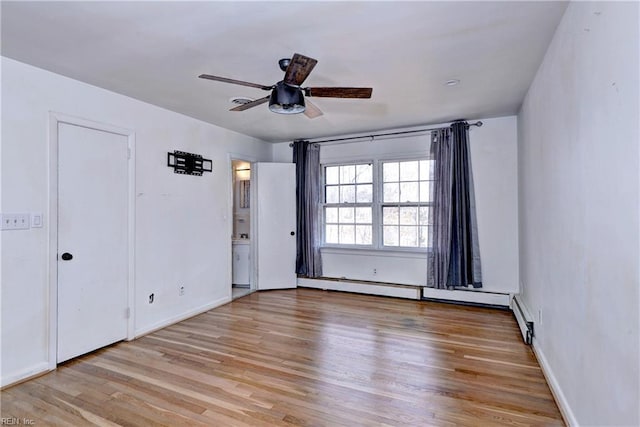 unfurnished room featuring baseboards, a ceiling fan, and wood finished floors