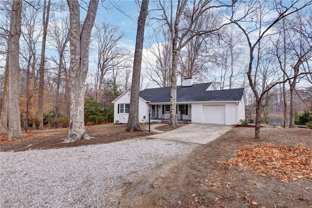 single story home with driveway, a garage, a chimney, and roof with shingles