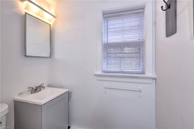 bathroom featuring toilet and vanity