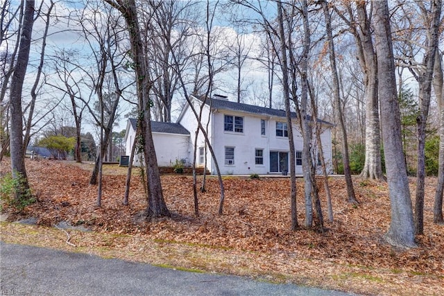 view of front of property featuring a chimney and stucco siding