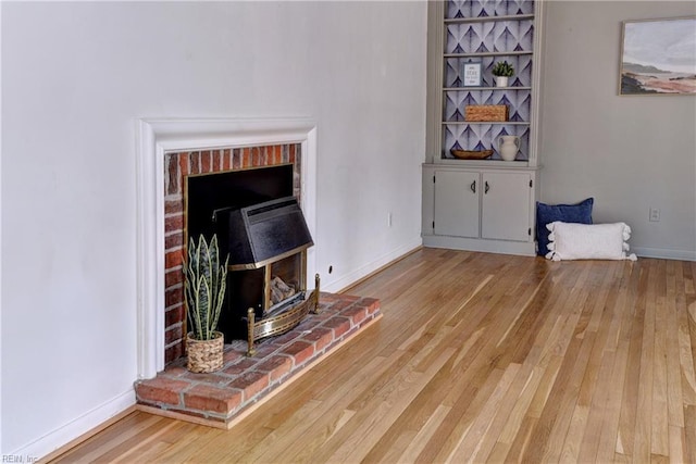 living room featuring wood-type flooring and baseboards