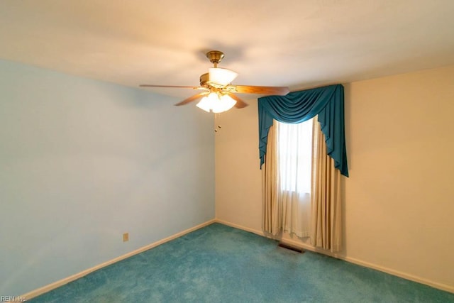 spare room featuring carpet, a ceiling fan, and baseboards