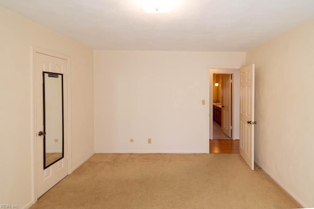 unfurnished room with light carpet