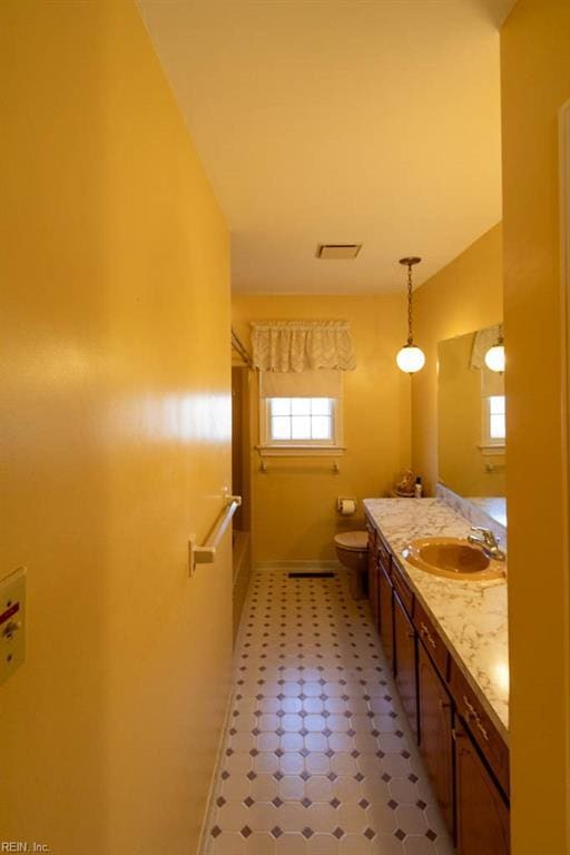 bathroom with toilet, tile patterned floors, visible vents, and vanity