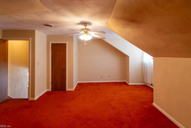 additional living space with baseboards, visible vents, a ceiling fan, lofted ceiling, and carpet floors