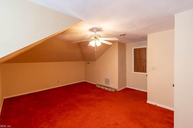 bonus room featuring visible vents, carpet flooring, vaulted ceiling, ceiling fan, and baseboards