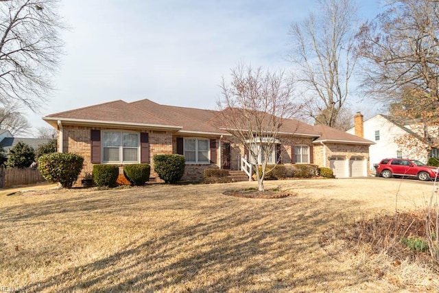 ranch-style home featuring an attached garage, brick siding, fence, roof with shingles, and a front yard