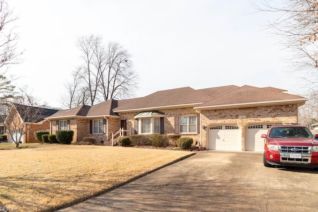 ranch-style house with brick siding, roof with shingles, an attached garage, driveway, and a front lawn