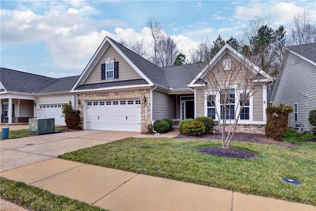 view of front of home with concrete driveway, a front lawn, stone siding, and cooling unit